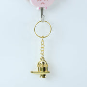 Golden Shivling metal keychain resting on a flat surface highlighting golden finish