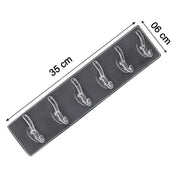 Elegant golden and transparent 6-pin hooks providing storage on a bathroom wall.