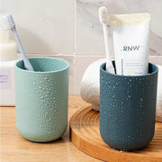 Multipurpose wall mount holder neatly storing toothbrushes, toothpaste, and cups, enhancing bathroom organization.