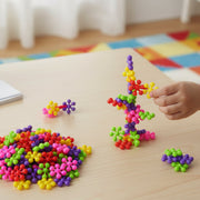 Hands assembling colourful building blocks toy set for creative learning