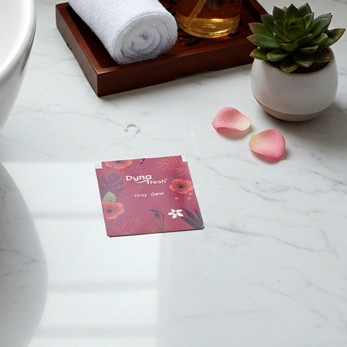 View of the compact Rosy Dew hanging gel air freshener, ready for use.