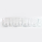 Stackable glass tumblers and mugs, part of a durable and practical drinkware collection.