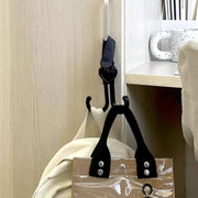 Parent pushing a stroller with the convenient stroller hook holding essentials.