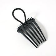 Hair styling comb clip securing hair in a voluminous bun style
