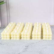 Close-up of decorative LED flameless cube candle showing bubble design and warm glow