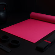 Yoga mat rolled up with a carrying strap, ready for travel.