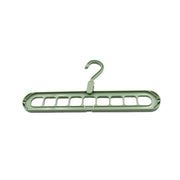 Organized wardrobe interior with multi-hole plastic hangers maximizing storage space.