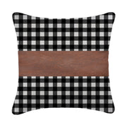 A set of contemporary leather pillow covers arranged on a comfortable armchair.
