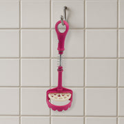 Easy-to-clean food-grade potato masher under running water.