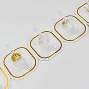 Transparent adhesive hooks installed on a white wall, blending seamlessly with home decor.