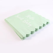 Tissue napkins with scalloped edges and baby party theme text in mint green
