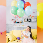 Assorted party balloons in red, blue, green, and yellow hues.