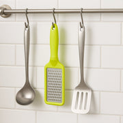 The ergonomic black plastic handle of the stainless steel grater, designed for a comfortable grip.