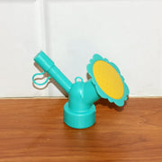 Bottle sprinkler head nozzle showing compact, portable gardening accessory