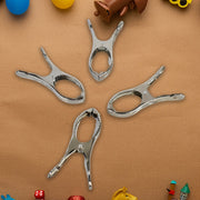 Durable stainless steel clothespins showcasing strong grip on towels.
