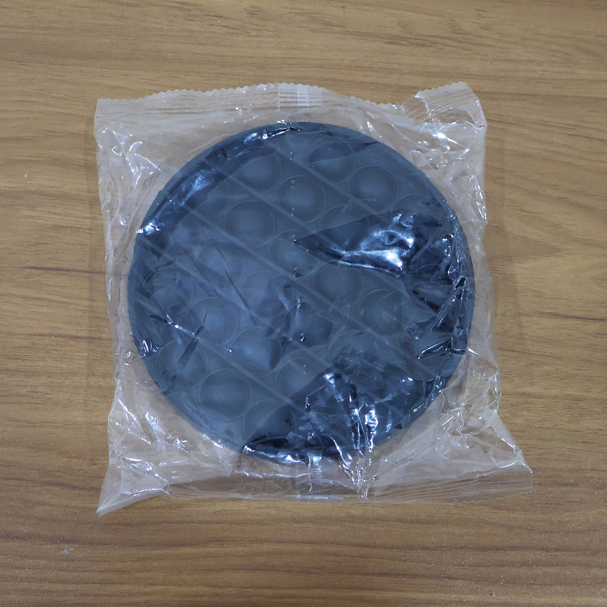 Back view of round silicone Pop It fidget toy for sensory play