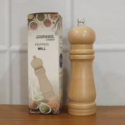 Compact wooden manual pepper mill for consistent spice grinding and seasoning