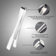 Set of two stainless steel serving tongs on a clear glass plate.