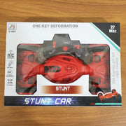 Wireless remote control placed beside stunt car toy