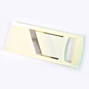 Close-up of the adjustable thickness control knob on the vegetable slicer.