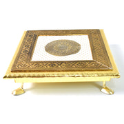 Detail shot of the golden Pooja Bajot featuring a delicate lotus motif.