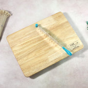 Knife blade detail resting on wooden cutting board