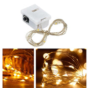 Close-up of battery powered LED fairy lights with copper wire glowing warmly