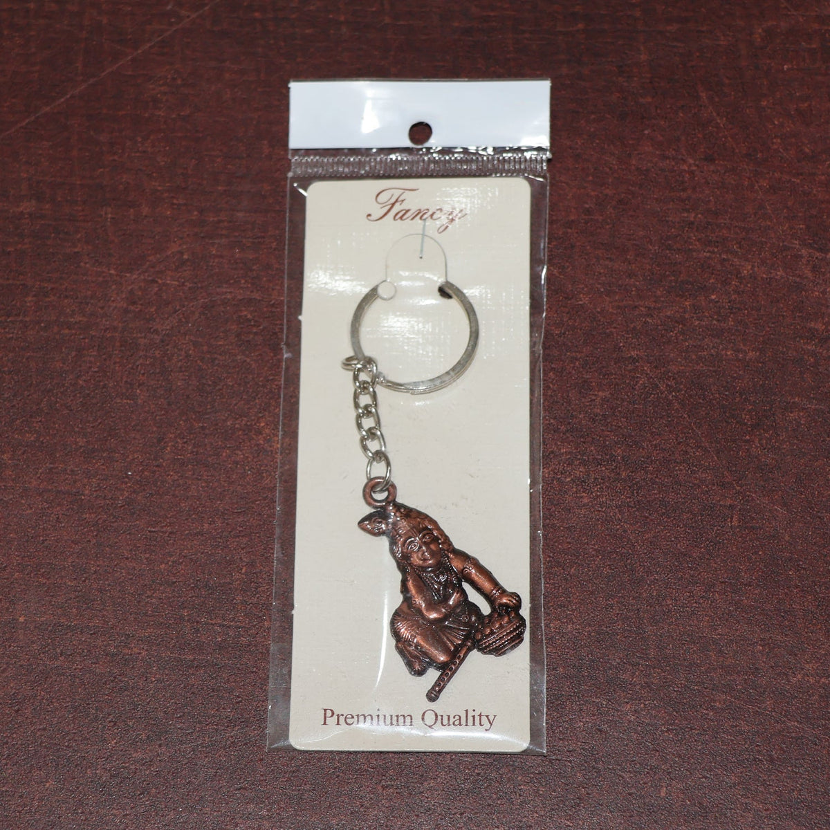 Side view of Bal Krishna metal keychain with sturdy chain and ring