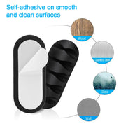 Multi-use cable clips securing headphones and USB wires on a bedside table.