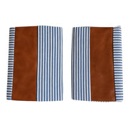 Pair of leather and cotton pillow covers on a modern sofa