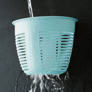 Collection of hanging plastic storage baskets in various colors, demonstrating versatility.