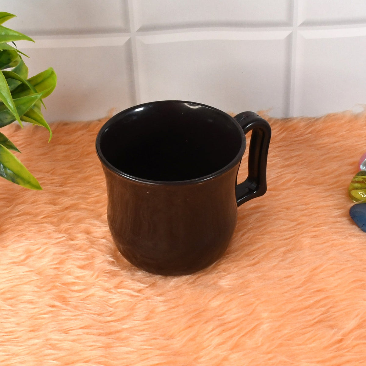 Stack of lightweight plastic mugs, demonstrating their compact and space-saving design.