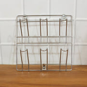 Close-up of stainless steel wall-mounted mug and cup holder rack