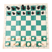Plastic chess set pieces arranged on the roll-up green and white chess board