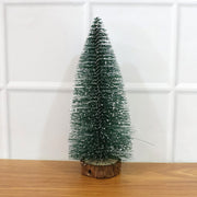 Miniature green Christmas tree with snow effect and sturdy wooden base for festive decor