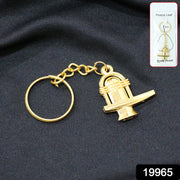 Close-up of golden Shivling metal keychain showing detailed craftsmanship