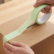 Tape sealing carton box in a shipping environment