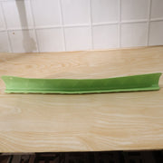 Side angle view of the flexible kitchen sink splash guard on a wooden counter.