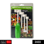 Hand using the vegetable corer tool to hollow out a green vegetable.