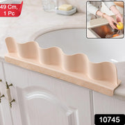Anti-splash kitchen sink guard protecting countertop from water spill