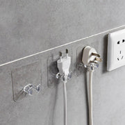 Set of transparent wall storage hooks arranged in a kitchen for efficient organization.