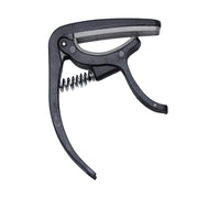 Wagtail guitar capo securely clamped on an acoustic guitar neck.