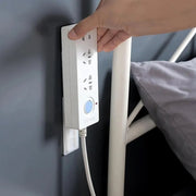 The compact Self Adhesive Plug Organizer fixing various cables behind a TV unit for a tidy look.