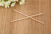 Bundle of natural bamboo skewers tied with string for display.
