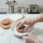 Disposable plastic gloves in transparent design for kitchen use