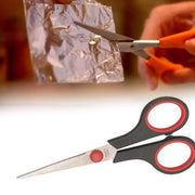 Close-up of the ergonomic handle and sharp blade of a Quickslice scissor.