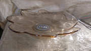 A side view of a flower shaped kids plastic plate, showing its shallow depth suitable for snacks and small meals.