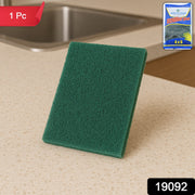 Green multipurpose kitchen scrubber pad removing grime on utensils