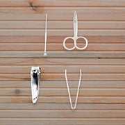 The AuriGlam mini nail clipper set shown with its protective plastic storage case.