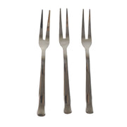 Three small appetizer forks laid out for serving snacks
